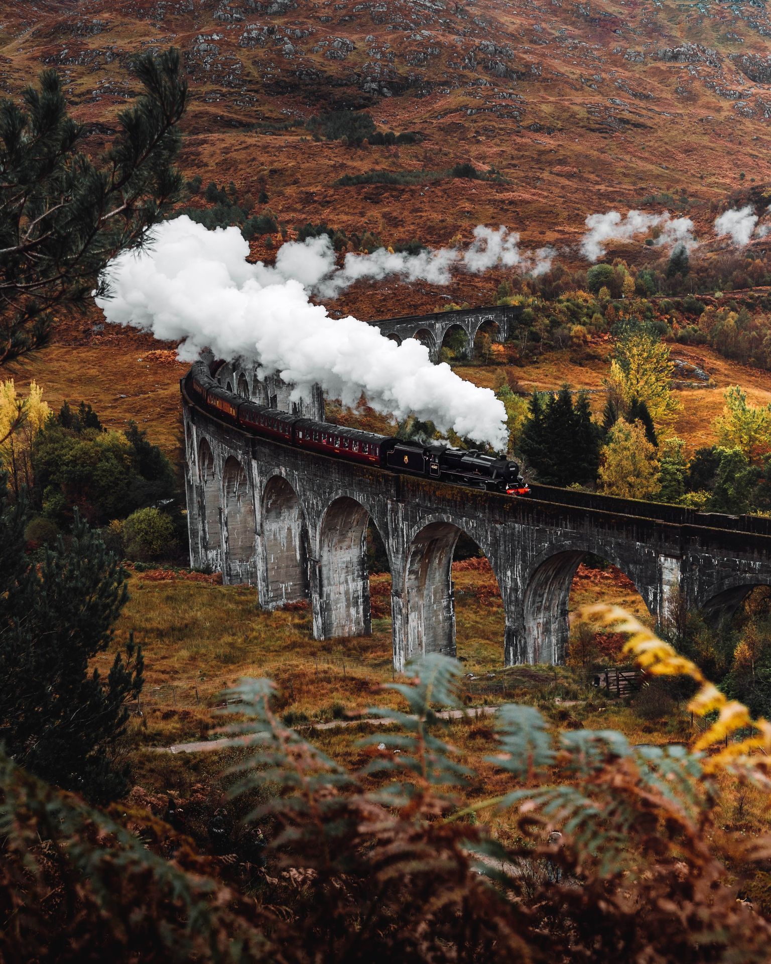 a train on a track with smoke coming out of it