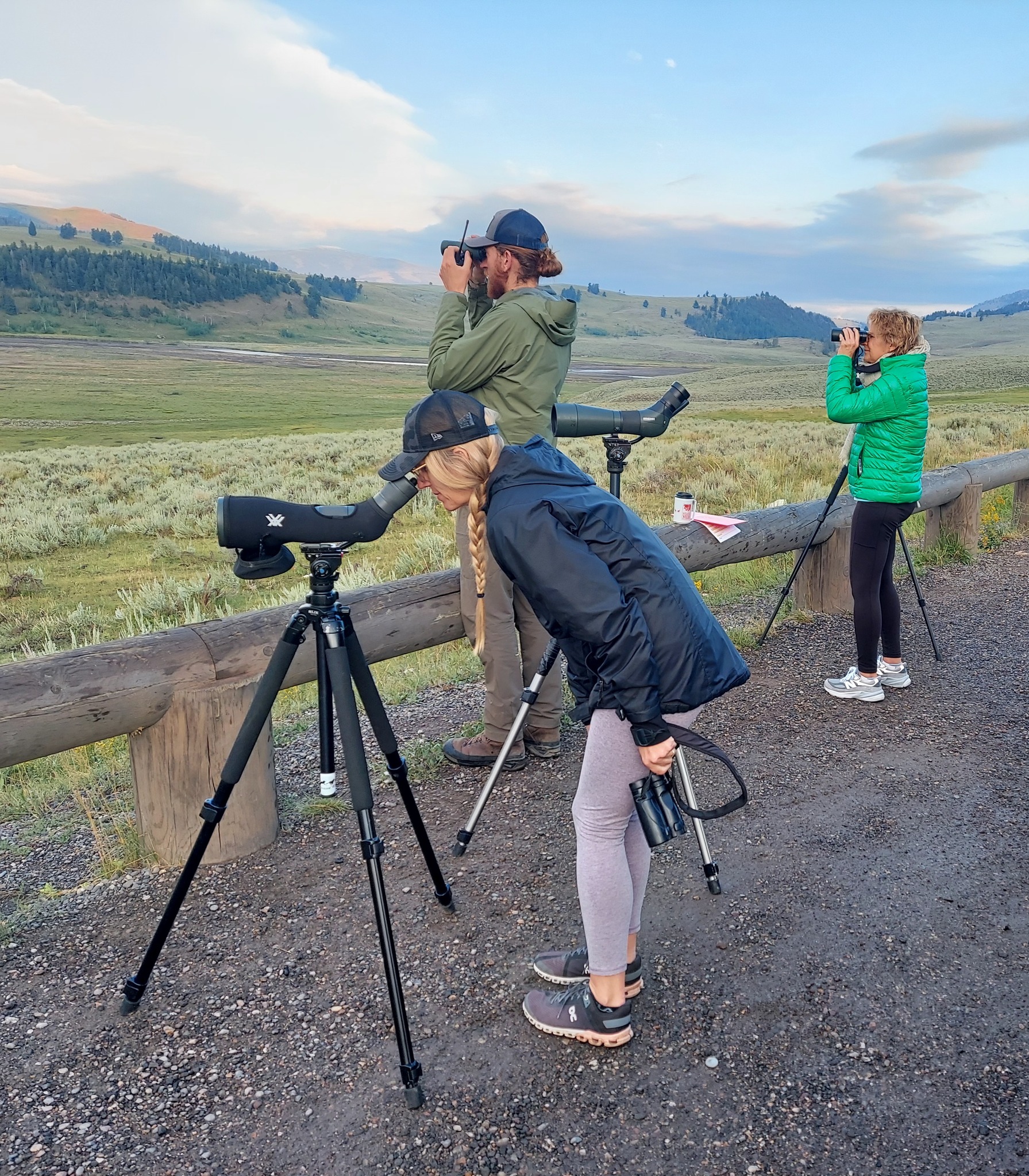 a group of people standing on top of a dirt field